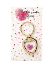 Brelok - amulet na zdjęcie z hasłem Kocham. Wydawca: Jawi. Dadada.pl Opakowanie Brelok - amulet na zdjęcie z hasłem Kocham