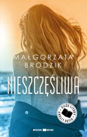 Nieszczęśliwa. Duże Litery. Autor: Małorzata Brodzik. Dadada.pl Okładka książki Nieszczęśliwa. Duże Litery